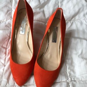 Bright orange pumps
